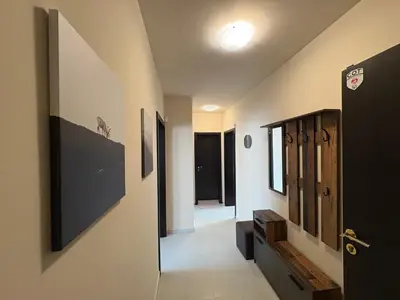 a hallway with a door leading to a room with windows at Apart-Tundzha 6 in Sofia