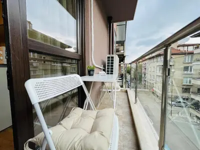 a white chair sitting on a balcony with a window at Apart-Tundzha 6 in Sofia