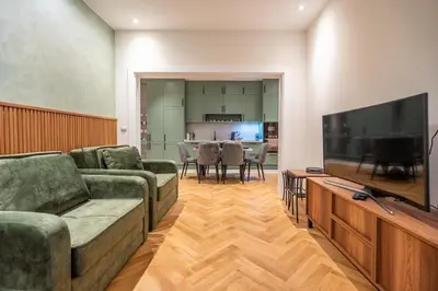 a living room with two couches and a large flat screen tv at Elegant & Stylish 2-Bedroom Apartment in Sofia