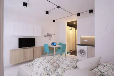 a bedroom with a bed and a table and a tv at Natan Royal in Sofia