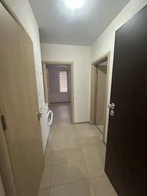 a hallway with a toilet in a room with a door at The Last Dollar in Sofia
