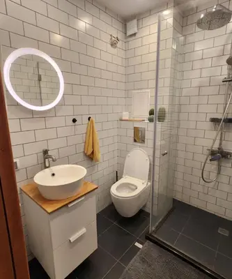 a bathroom with a toilet and a sink and a shower at Mallside Residences in Sofia