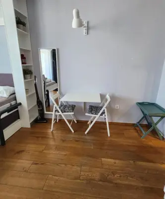a room with two chairs and a white table at Mallside Residences in Sofia