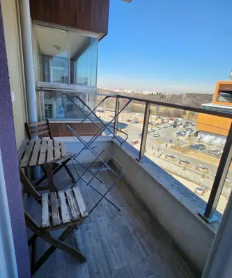 a balcony with a bench and a view of a parking lot at Mallside Residences in Sofia