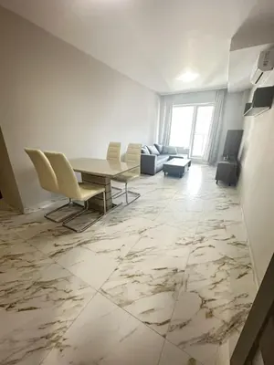a living room with a table and chairs at No Remorse Tower & private parking in Sofia