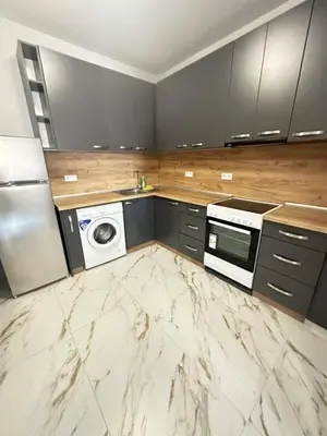 a large kitchen with a washer and dryer in it at No Remorse Tower & private parking in Sofia