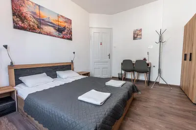 a bedroom with a bed with two towels on it at Vitoshka Inn - R1 in Sofia