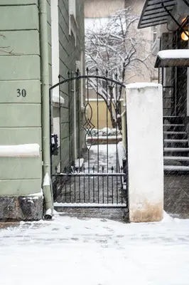 a iron gate in front of a building with snow at Vitoshka Inn - R1 in Sofia