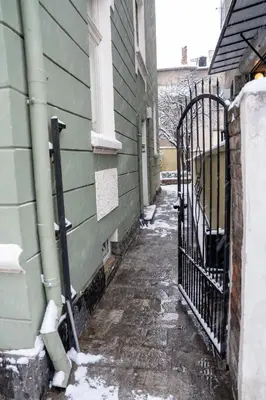 an alley with snow on the side of a building at Vitoshka Inn - R1 in Sofia