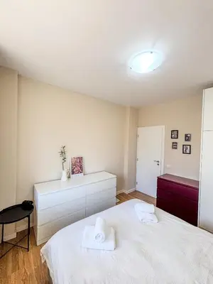 a bedroom with two white towels on a bed at Scandi Suite Business & Leisure in Sofia