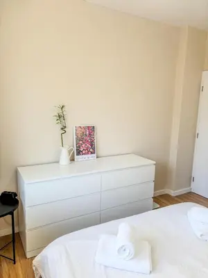 a bedroom with a white dresser with towels on it at Scandi Suite Business & Leisure in Sofia