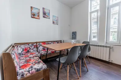 a dining room with a couch and a table at Vitoshka Inn - R2 in Sofia