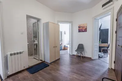 an empty room with a door and a chair in it at Vitoshka Inn - R2 in Sofia