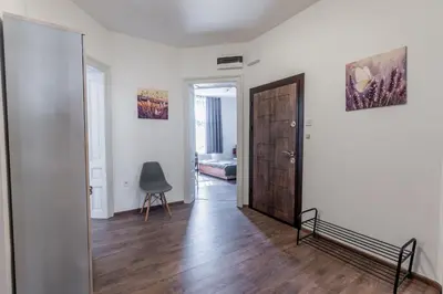 a hallway with a door and a chair in a room at Vitoshka Inn - R2 in Sofia