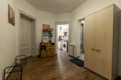 an apartment with a hallway with a kitchen and a large cabinet at Vitoshka Inn - R3 in Sofia