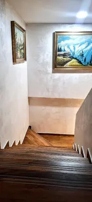 a staircase in a building with a painting on the wall at Vila Nikol Apt #3 in Raduil