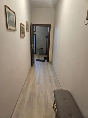 an empty hallway with a door and a wooden floor at Hot Spot 2bdrm apartment 1 in Sofia