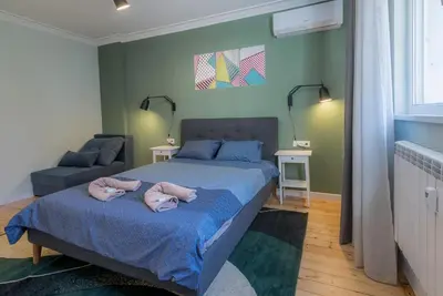 a bedroom with a bed with two pink towels on it at 35 Seconds Away From the Main Street, Free Secured Parking in Sofia
