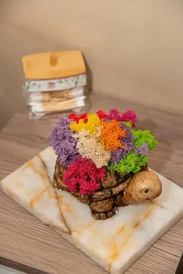 a vase filled with flowers sitting on a table at Luxury Stays Kapana Plovdiv in Plovdiv
