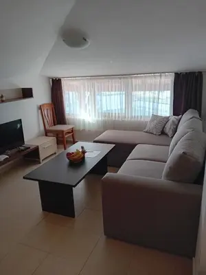 a living room with a couch and a coffee table at Belvedere Holiday Club Apartment 503 in Bansko