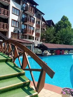 a large swimming pool in front of a building at Belvedere Holiday Club Apartment 503 in Bansko