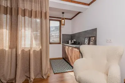 a living room with a chair and a counter at АРТ Къща Широка Лъка in Shiroka Lŭka