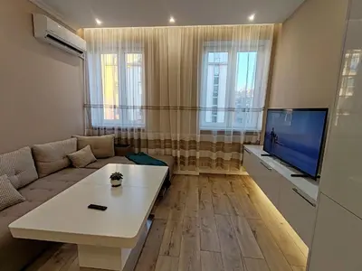 a living room with a couch and a tv at Дрийм in Plovdiv