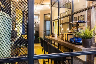 a room with a table and chairs and a window at 5 Vintage Guest House in Sofia
