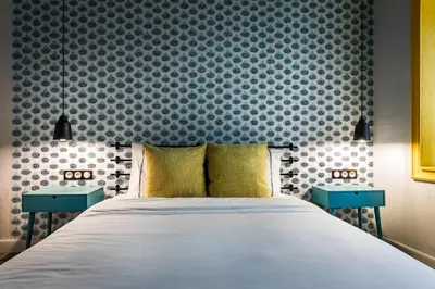 a bedroom with a bed and two blue tables at 5 Vintage Guest House in Sofia