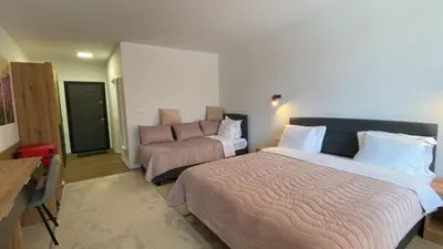 a bedroom with a bed and a couch in it at SUGARFAME- Guest House in Sarnitsa