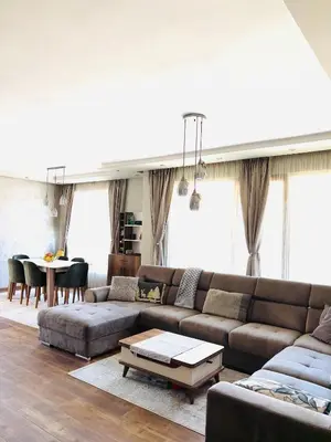 a living room with a couch and a table at Luxury Park Villa in Sandanski