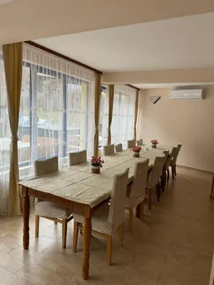 a conference room with a long wooden table and chairs at Къща за гости Стефани in Devin