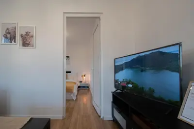 a living room with a large flat screen tv at Hyggemate - 1 Bed Room Cozy Apartment in Sarnitsa in Sarnitsa