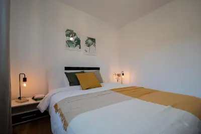 a bedroom with a large white bed and two lamps at Hyggemate - 1 Bed Room Cozy Apartment in Sarnitsa in Sarnitsa