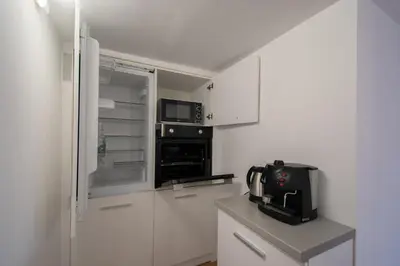 a small kitchen with white cabinets and a microwave at Hyggemate - 1 Bed Room Cozy Apartment in Sarnitsa in Sarnitsa