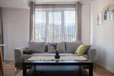 a living room with a couch and a table at Hyggemate - 1 Bed Room Cozy Apartment in Sarnitsa in Sarnitsa