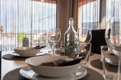 a table with glasses and a bottle of wine at Hyggemate - 1 Bed Room Cozy Apartment in Sarnitsa in Sarnitsa