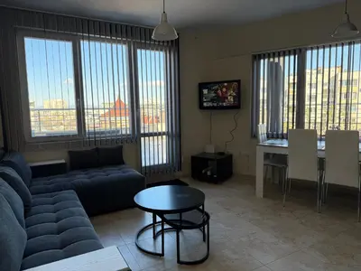 a living room with a couch and a table at Apartment near Vitosha mountain, self check-in, with underground parking in Sofia