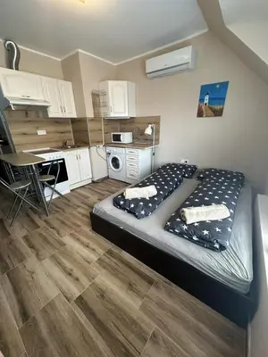 a small bedroom with a bed and a kitchen at Mirror Residenced & private parking in Sofia