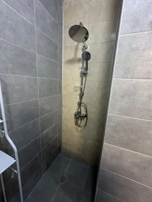 a shower with a shower head in a bathroom at Mirror Residenced & private parking in Sofia
