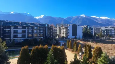 a city with buildings and mountains in the background at Pirin Views Aspen A337 in Razlog