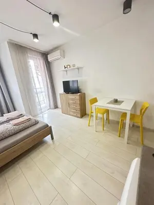 a bedroom with a bed and a table and a dining room at Urban Nest 7 studio in Sofia