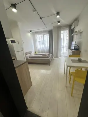 a large living room with a bed and a table at Urban Nest 7 studio in Sofia
