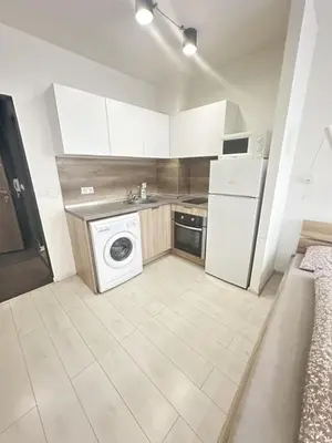 a kitchen with a washer and a refrigerator and a dishwasher at Urban Nest 7 studio in Sofia