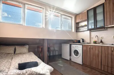 a small bedroom with a bed and a washer and dryer at Studio Subway in Sofia