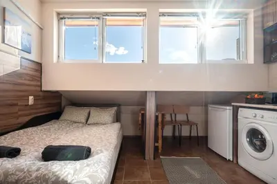 a small bedroom with a bed and a washing machine at Studio Subway in Sofia