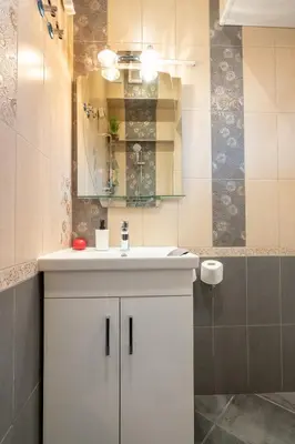 a bathroom with a white sink and a mirror at Studio Subway in Sofia