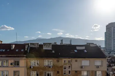 a group of buildings with mountains in the background at Studio Subway in Sofia