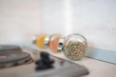 a glass jar filled with seasoning on top of a counter at Studio Subway in Sofia
