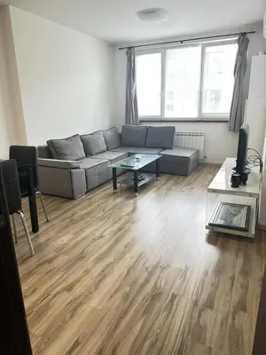 a living room with a couch and a table at Metropolitan Paradise & private parking in Sofia